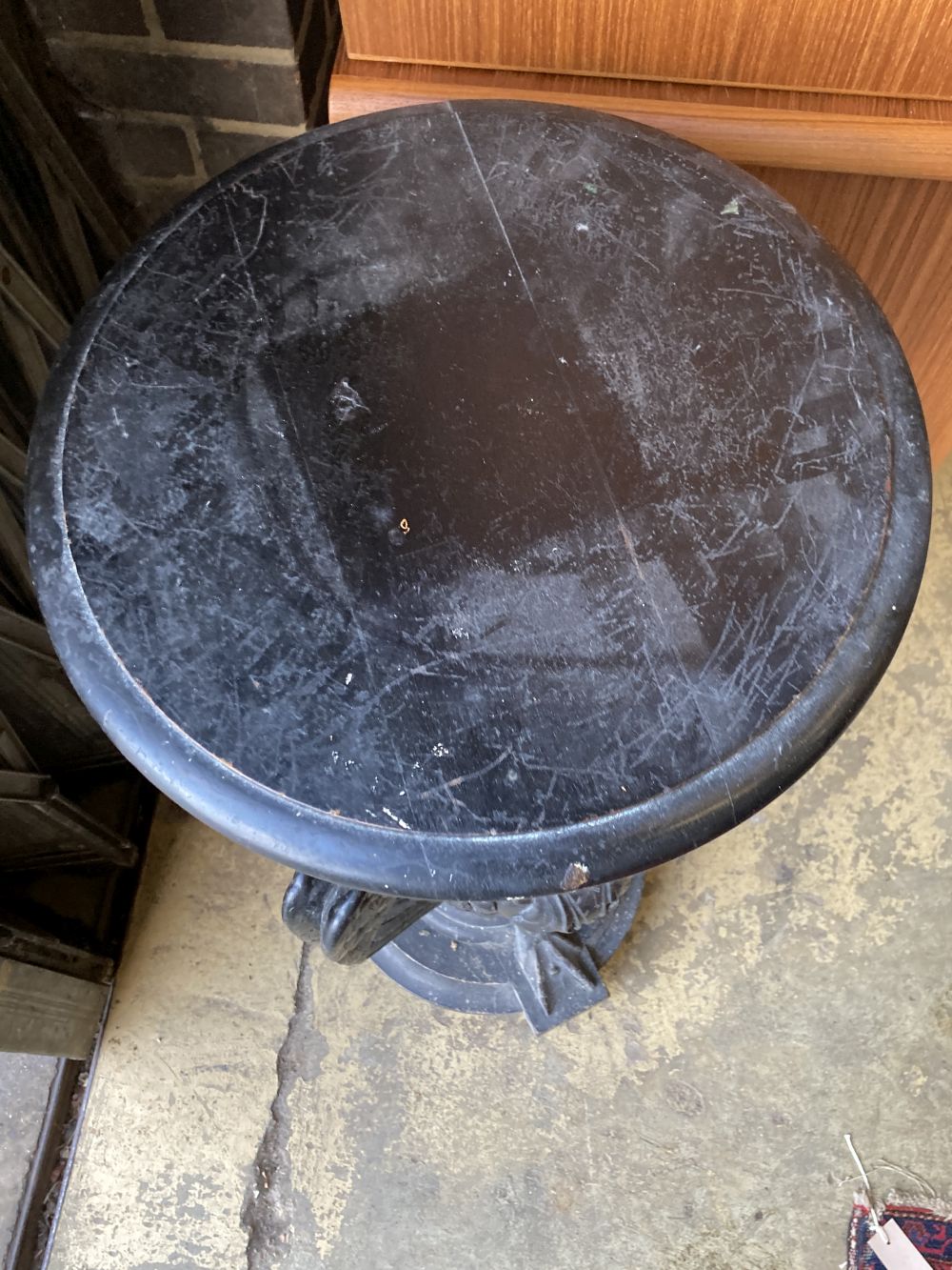 A Victorian ebonised carved wood lamp table in the form of three monopodiae stylised birds, 38cm diameter, height 94cm